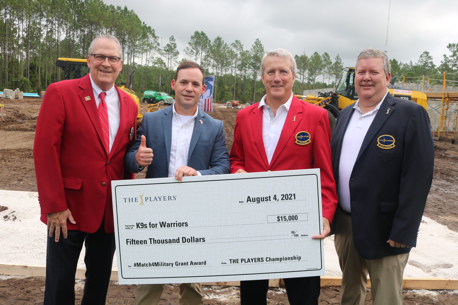 THE PLAYERS past chairman Murray Beard (far left), 2022 tournament chairman Matt Welch (second from right) and vice chairman Lee Nimnicht (far right) present a $15,000 check to K9s For Warriors CEO Rory Diamond as part of THE PLAYERS Match4Military grant program.